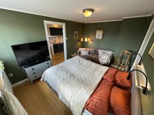 a bedroom with a bed and a flat screen tv at Stora Torget B&B in Eksjö