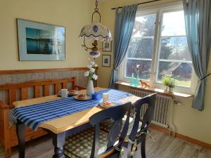 a dining room table with a blue and white checkered table cloth at Mistel in Filipstad