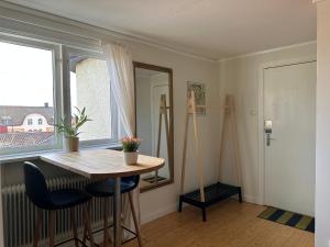 a dining room with a table and a window at Stora Torget B&B in Eksjö