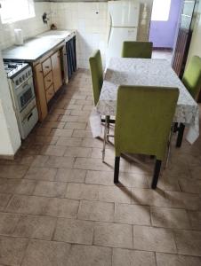 a kitchen with a table and chairs and a kitchen with a stove at Refugio Pampa - General Pico in General Pico