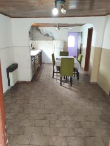 a kitchen and dining room with a table and chairs at Refugio Pampa - General Pico in General Pico +3 photos