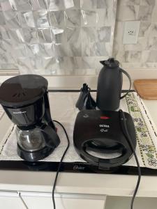 a black coffee maker on a kitchen counter at BAHIA FLAT Apt 222 in Salvador