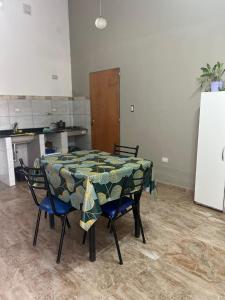 a table and chairs in a room with a kitchen at El rincon del viajero deptos in San Francisco del Monte de Oro +6 photos