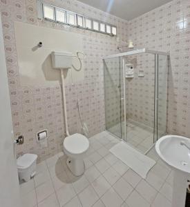 a bathroom with a shower and a toilet and a sink at Pousada Valmar in Aracaju +71 photos