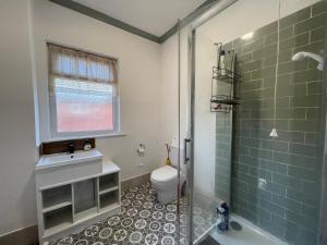 a bathroom with a shower and a toilet and a sink at Rose Cozy House in Stockton-on-Tees +86 photos