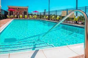 a large swimming pool with blue water in a hotel at Hampton Inn & Suites La Porte, TX in La Porte