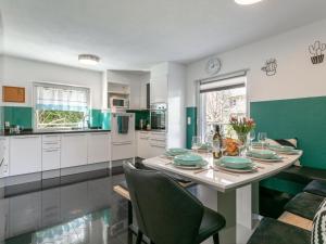 a kitchen with a table with green and white at Gästehaus Inntal in Radfeld