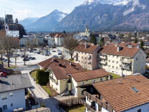 a town with buildings and mountains in the background at Gästehaus Inntal in Radfeld