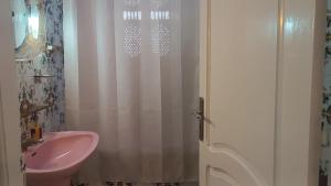 a bathroom with a pink sink and a shower at Maison Mira in Bizerte +5 photos