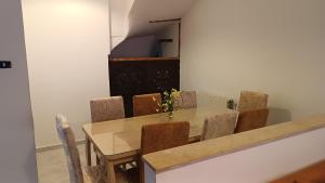 a dining room with a table and chairs at Maison Mira in Bizerte