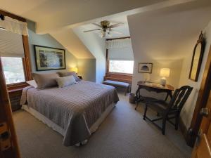 a bedroom with a bed and a chair and a desk at Bross Hotel B & B in Paonia