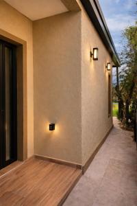 a patio with two lights on the side of a building at Departamento Parque, Asador y Pileta Privada, uso exclusivo in San Luis