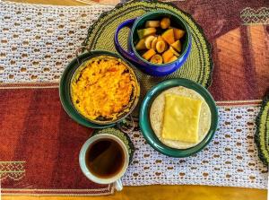 a table with bowls of food and a cup of coffee at Glamping Bosque del Colibri in Guatavita