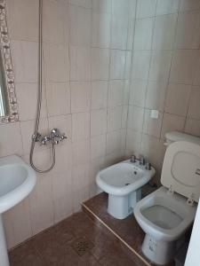 a bathroom with a toilet and a sink at Pin-up hostel in Rosario +36 photos