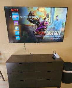 a flat screen tv sitting on top of a dresser at Oceanfront Views • Balcony + Top Hilo Location in Hilo