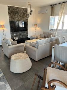 a living room with couches and a tv at Duplex Villa 4 rooms in Marsa Matruh