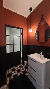 a bathroom with a white sink and a mirror at Design studio Margherita in Cinisello Balsamo