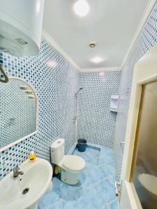a bathroom with a toilet and a sink at sun house tamraght in Tamraght Ouzdar