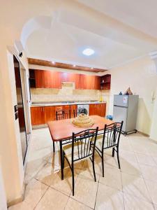 a kitchen with a table and chairs and a refrigerator at sun house tamraght in Tamraght Ouzdar +13 photos
