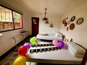 a room with a bed with balloons on it at Maliag Studio Type Room for Rent in Coron