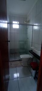 a bathroom with a shower and a toilet and a sink at Bozena Beach Stay in Itacaré