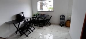 a dining room with two tables and chairs and a window at Bozena Beach Stay in Itacaré