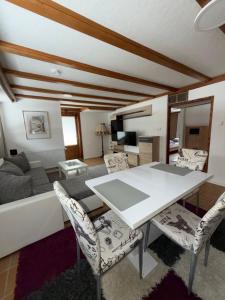 a living room with a white table and chairs at Ferienhaus HANA in St. Blasien +10 photos