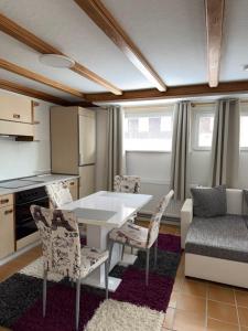 a kitchen with a table and chairs and a couch at Ferienhaus HANA in St. Blasien