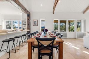 a kitchen and dining room with a table and chairs at Mulgrave House in Bellawongarah