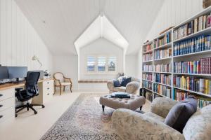 a room with a library with bookshelves at Mulgrave House in Bellawongarah