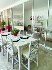 a wooden table and chairs in a living room at Bliss Villa Central Kuta in Kuta Lombok