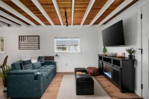 a living room with a couch and a flat screen tv at Cozy Coastal Cabin in Rockaway Beach
