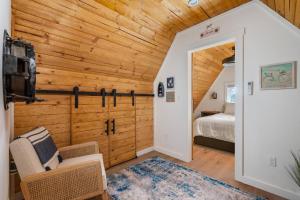 a bedroom with a bed and wooden walls at Cozy Coastal Cabin in Rockaway Beach