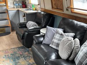 a living room with two leather chairs and a couch at The Erne Rambler in Silverhill
