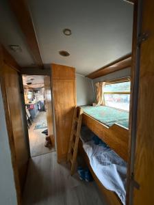 a small room with a bunk bed and a ladder at The Erne Rambler in Silverhill