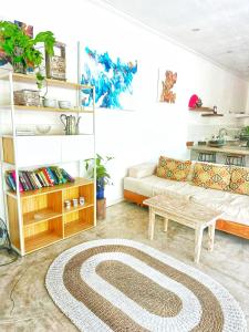 a living room with a couch and a table at Bliss Villa Central Kuta in Kuta Lombok