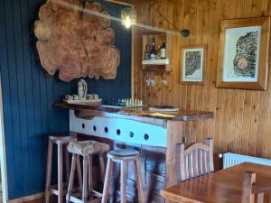 a bar in a restaurant with a wooden wall at Hostal Boutique El Vergel Azul in Castro