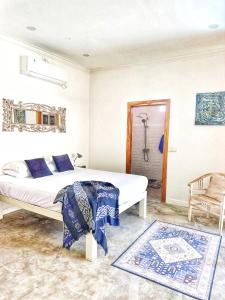 a bedroom with a large bed and a bathroom at Bliss Villa Central Kuta in Kuta Lombok +17 photos