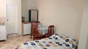 a dining room with a table with chairs at Gardenias Suites Lite in Ibarra