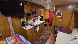 a small kitchen with a sink and a stove at Edith the Happy Camper in High Springs