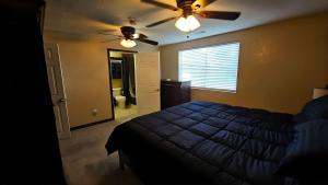 a bedroom with a bed and a ceiling fan at Lighthouse Basement Guest Suite in Provo