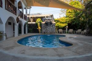a swimming pool with a water slide in a house at Nosara Hotel Playa Garza in Garza