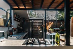 a kitchen with a counter with a stove top oven at Nosara Hotel Playa Garza in Garza