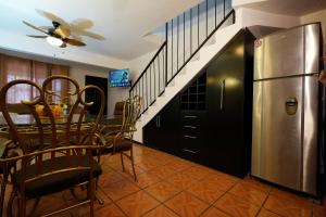 a dining room with a table and a refrigerator at Ribera Dorada in Monterrey +3 photos