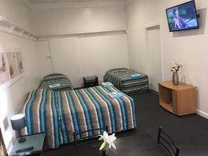 Postel nebo postele na pokoji v ubytování Albury Central Motel