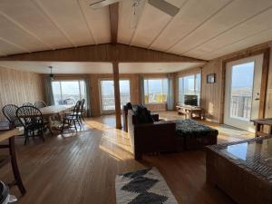 a living room with a couch and a table at 57151 Lighthouse Rd Home in Hatteras +13 photos