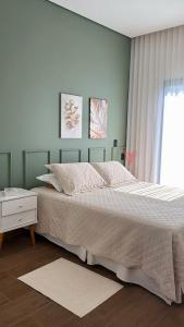 a bedroom with a large bed and a window at Cantinho Solis in Itupeva +96 photos