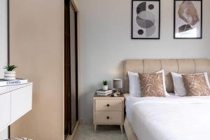a bedroom with a white bed and a nightstand with a bed sidx sidx sidx at Cairo Homes Nile View Studios Manial in Cairo