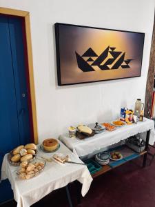 two tables with different types of food on them at Pousada Casa Matriz in Itabirito