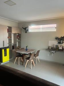 a kitchen and dining room with a table and chairs at Allmedhouse in São Luís